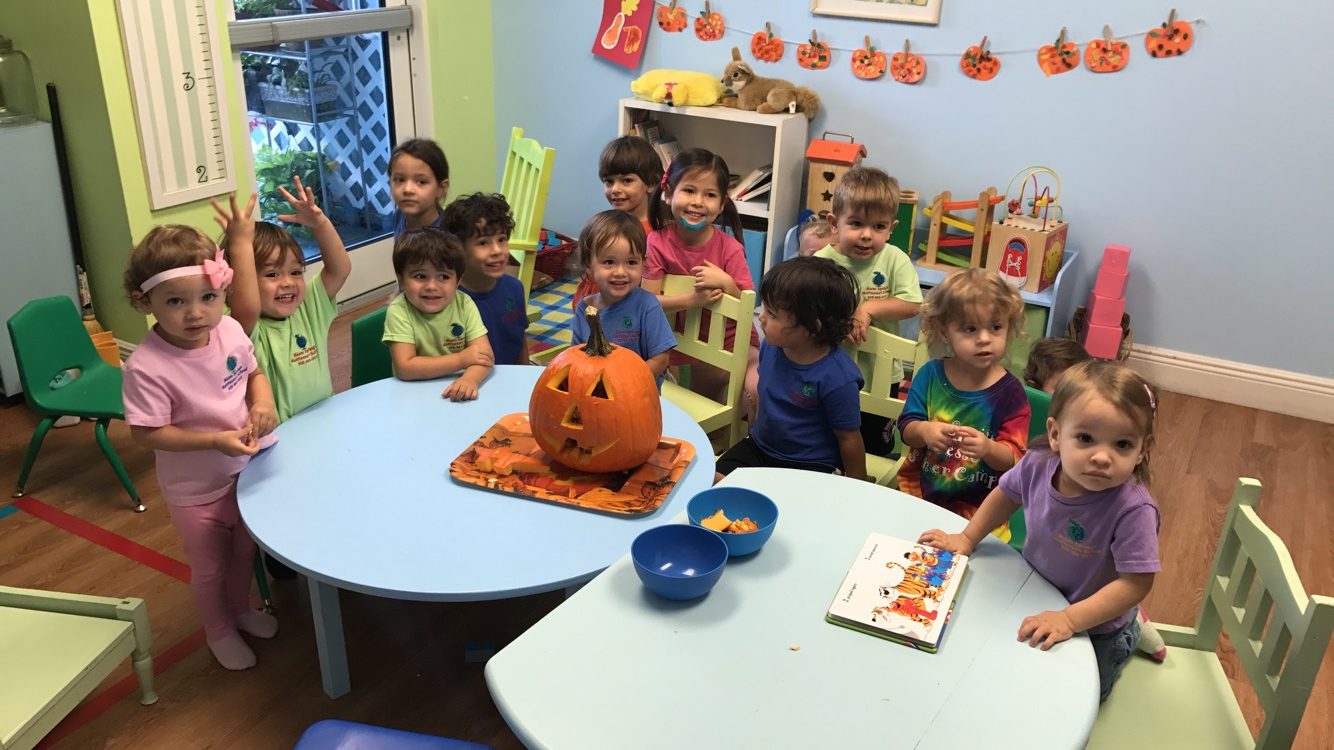 Children gathered around the table for a group classroom activity