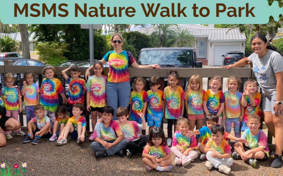 Group of children in tie-dye shirts on a nature walk to the park