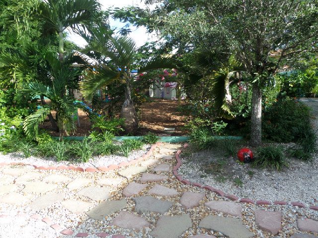 Shaded stone pathway winding through the school garden